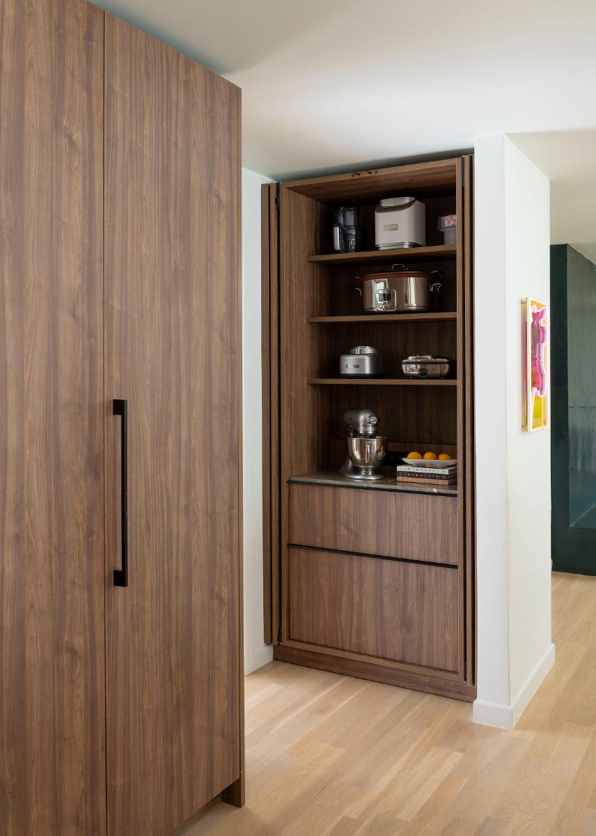 doors open to of an appliance closet in an eggersmann-designed Preston Hollow kitchen renovation