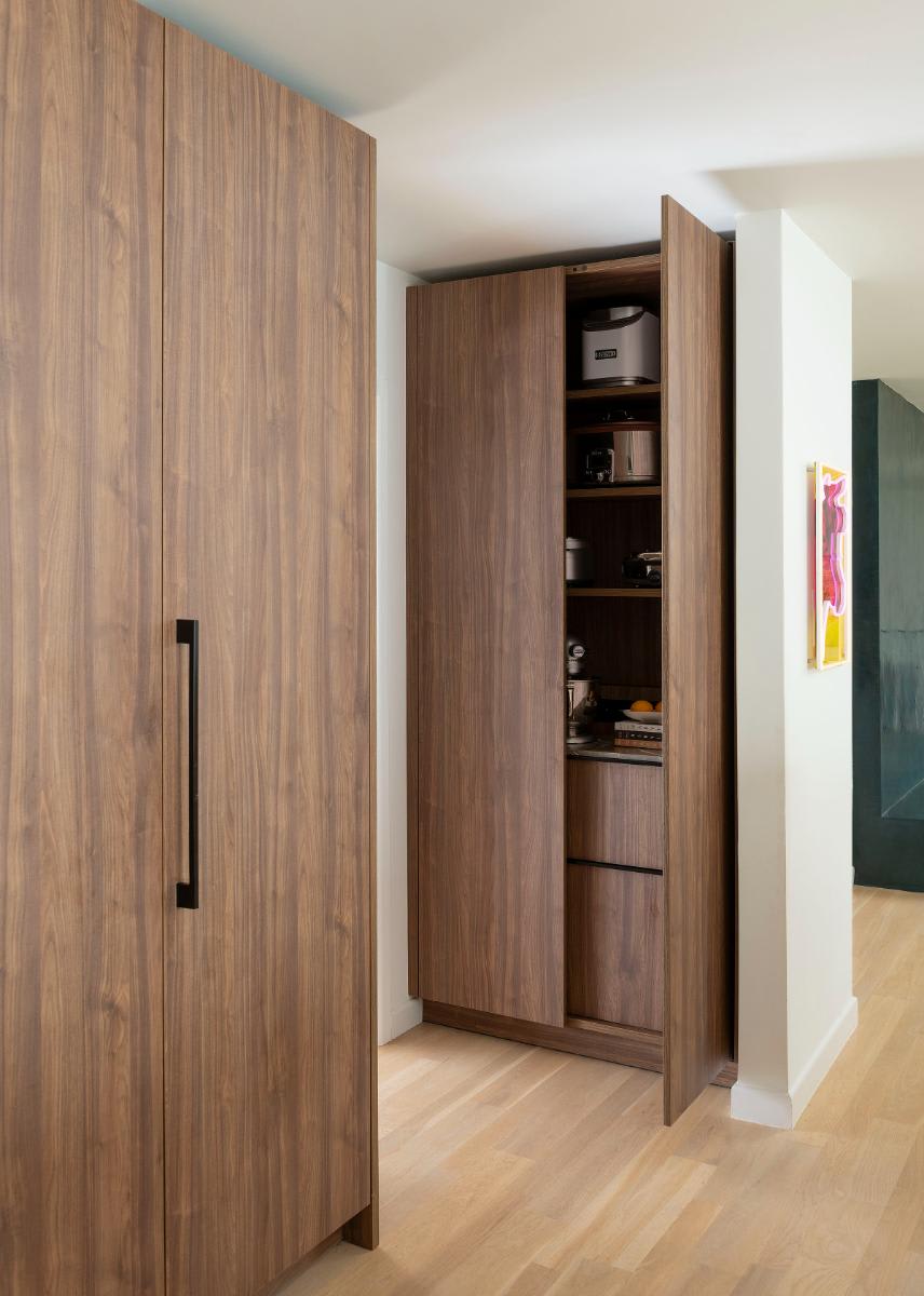 ajar right door of an appliance closet in an eggersmann-designed Preston Hollow kitchen renovation