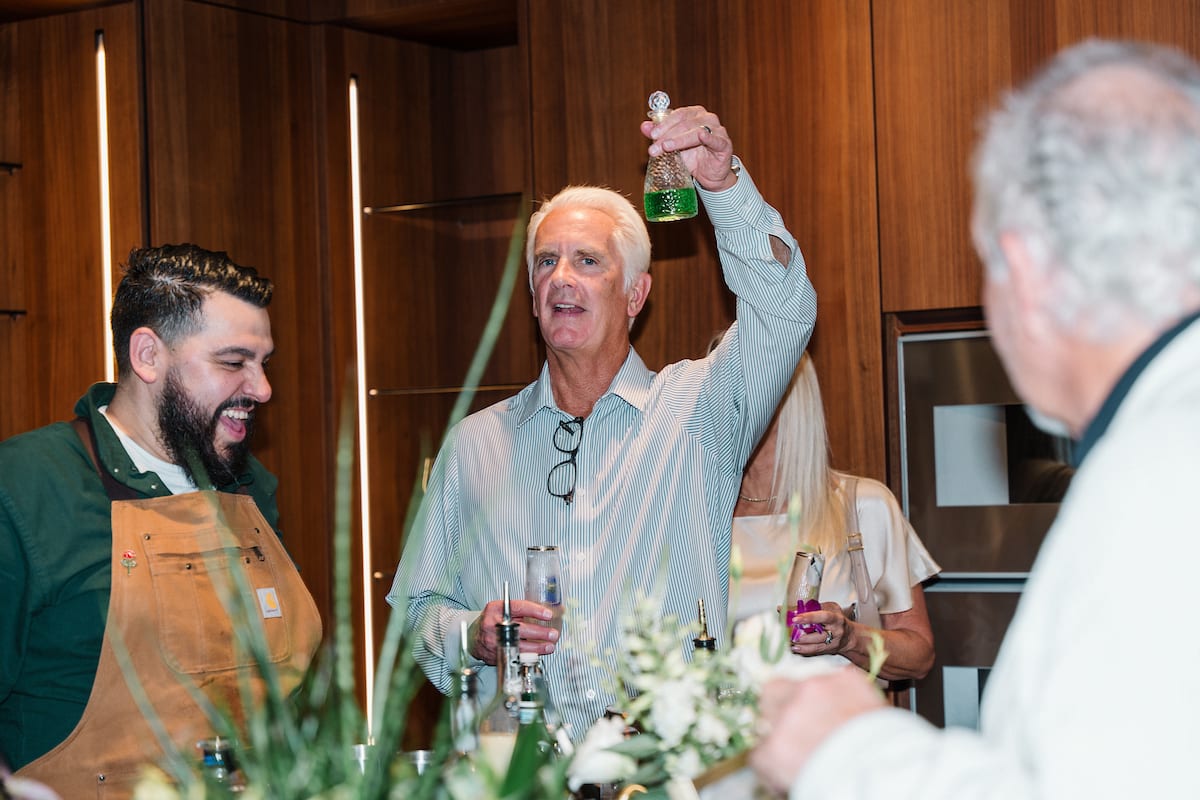 a guest toasts the crowd at a tequla tasting event at the eggersmann laguna showroom