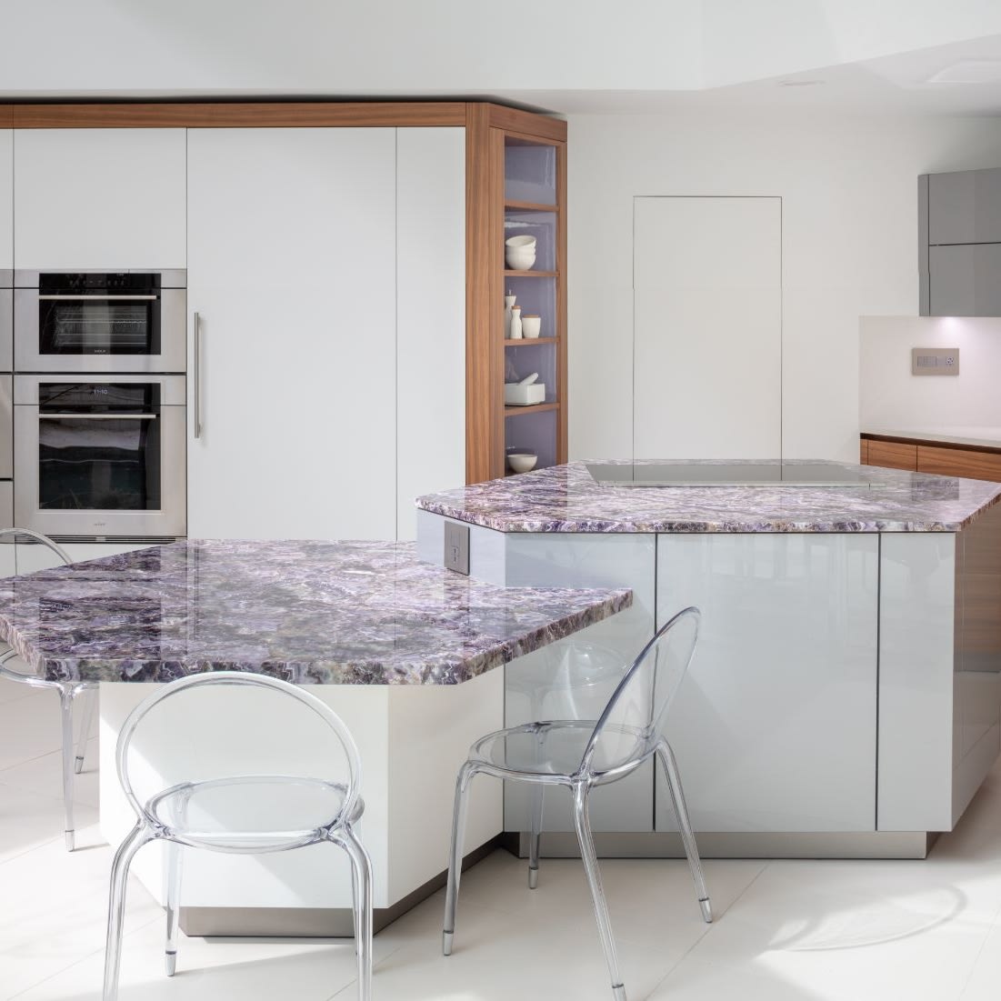 two-tier hexagonal islands designed by eggersmann are topped with a very peri-inspired stone
