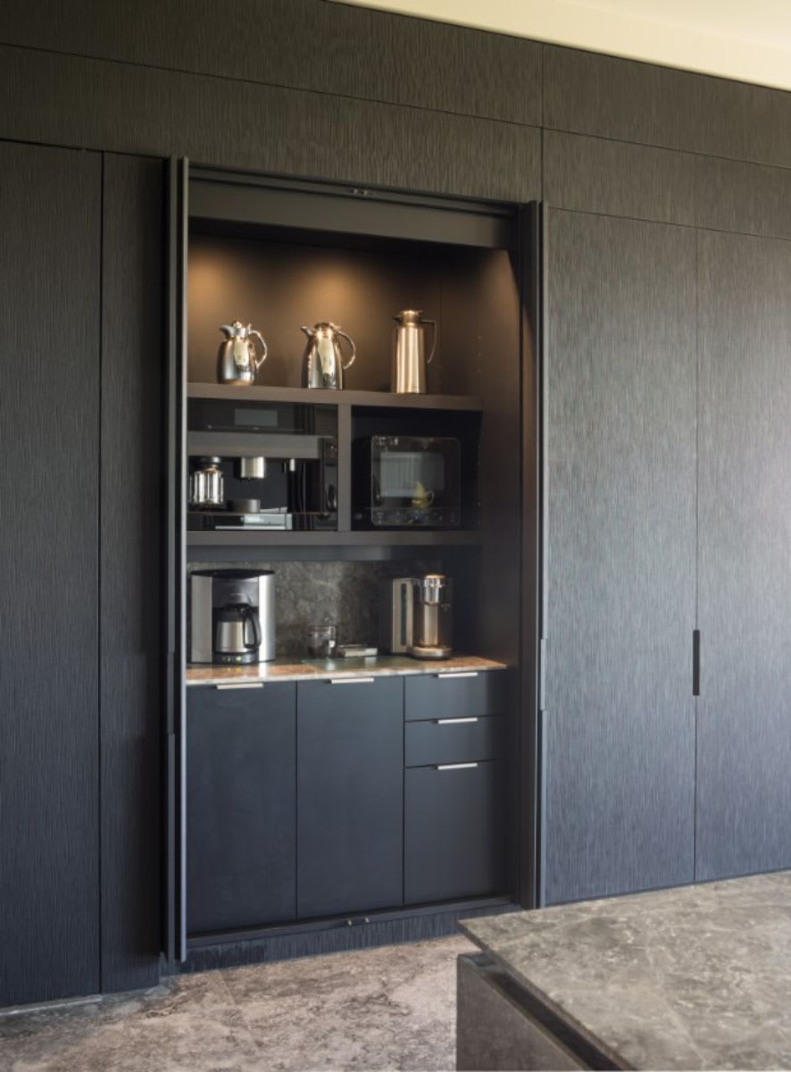 pocket doors on the coffee bar of this luxury modern kitchen