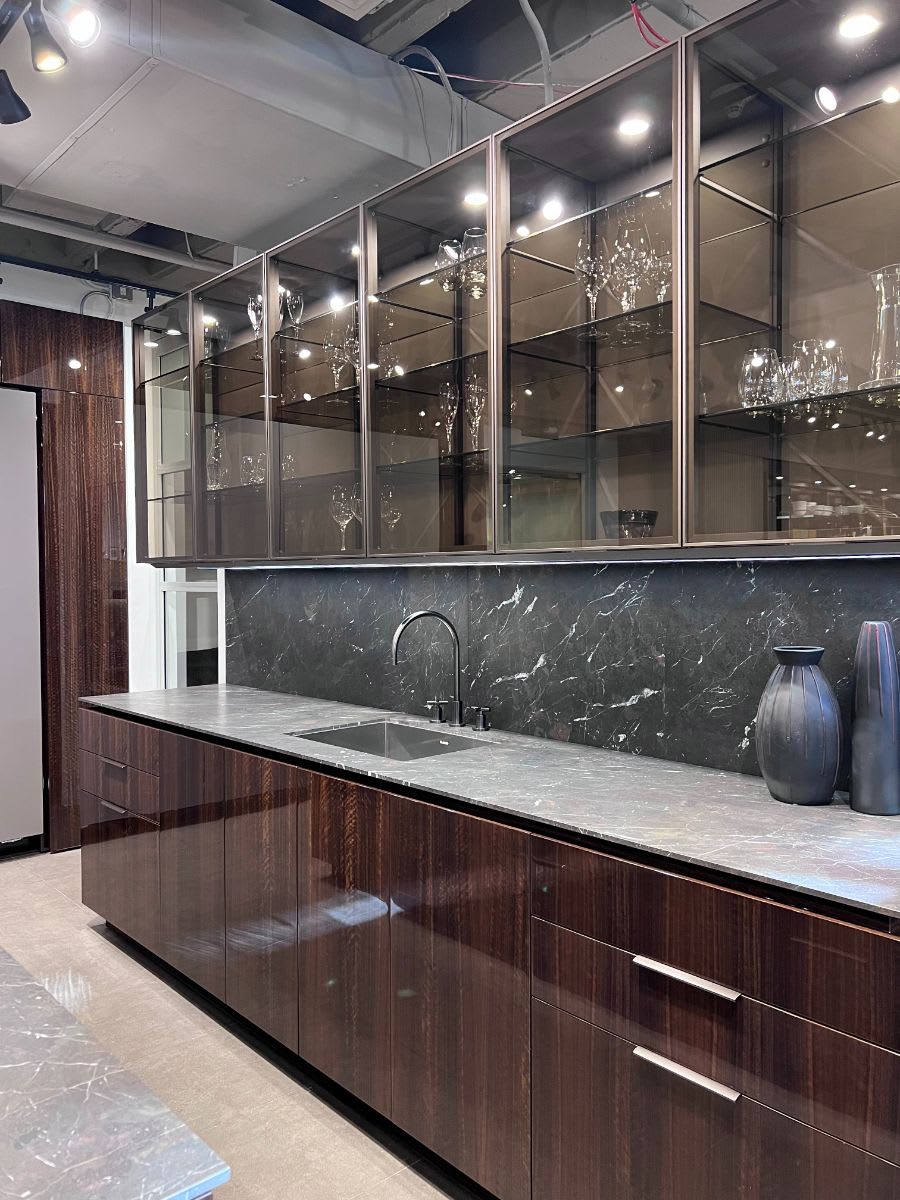 new glance aluminum-framed glass cabinet fronts in a kitchen display in eggersmann new york showroom