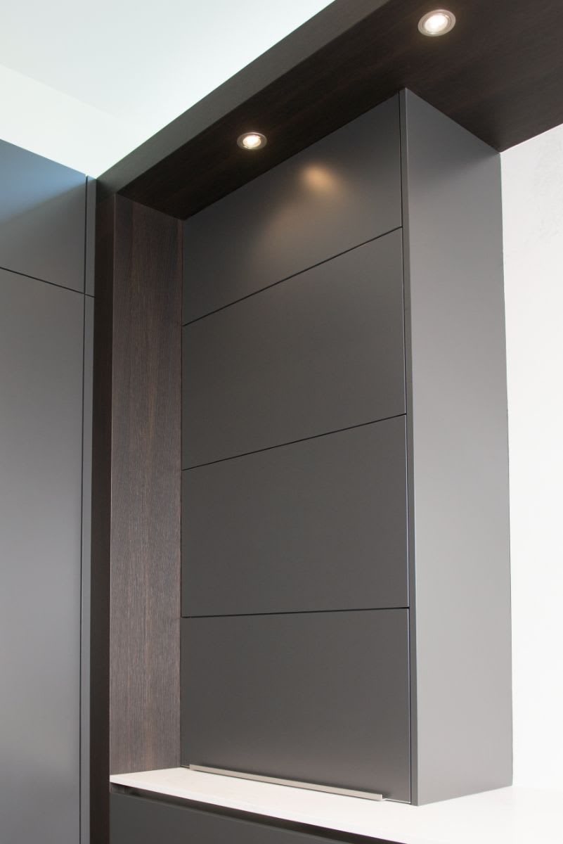 automated vertical-swing doors when closed hide a coffee bar designed by eggersmann