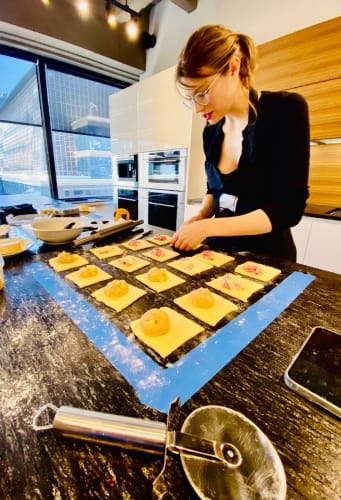 sarah wiley, eggersmann nyc designer filling danish pastry dough squares in the live kitchen in the showroom