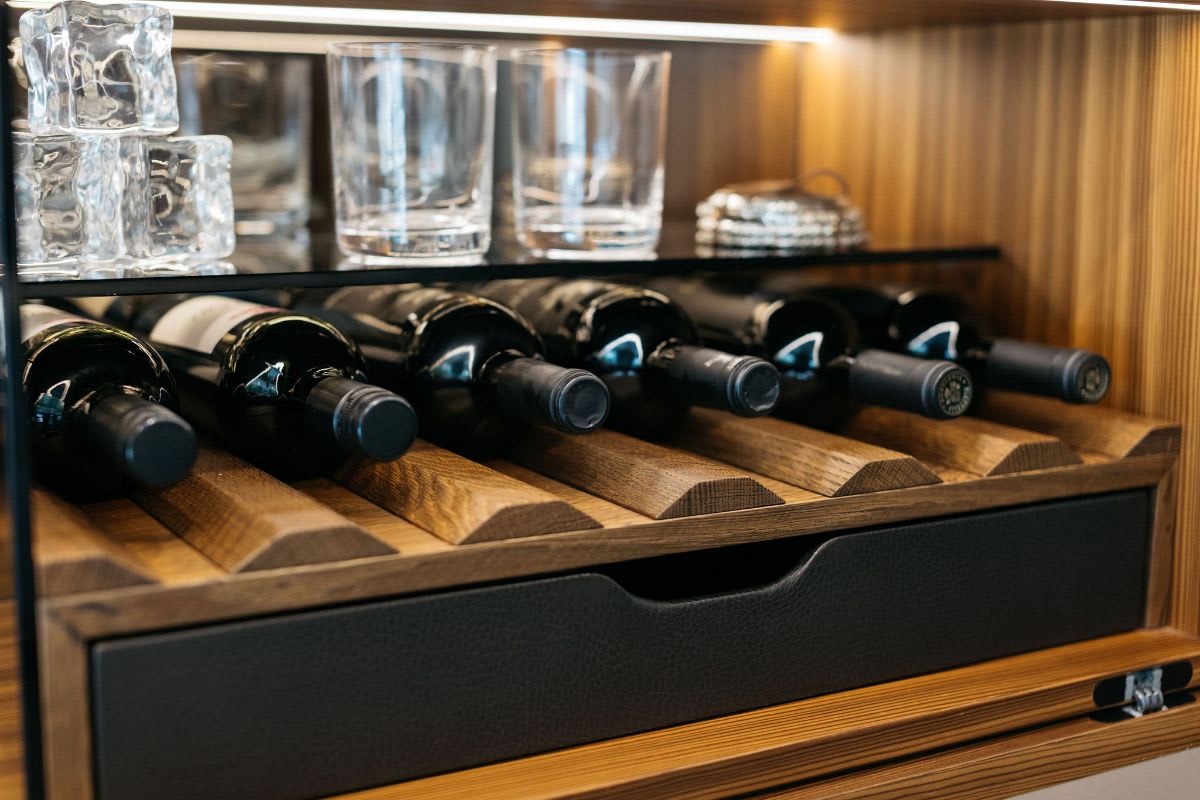 drawer for bar utensils in leather-lined drawer of an eggersmann-designed bar