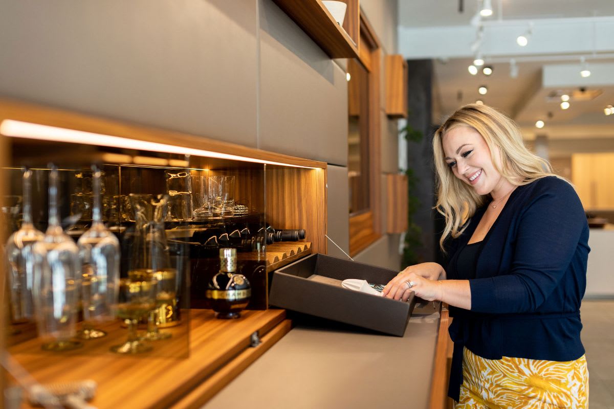 eggersmann drawer interiors include organizers inside hidden bars to keep bar utensils within easy reach