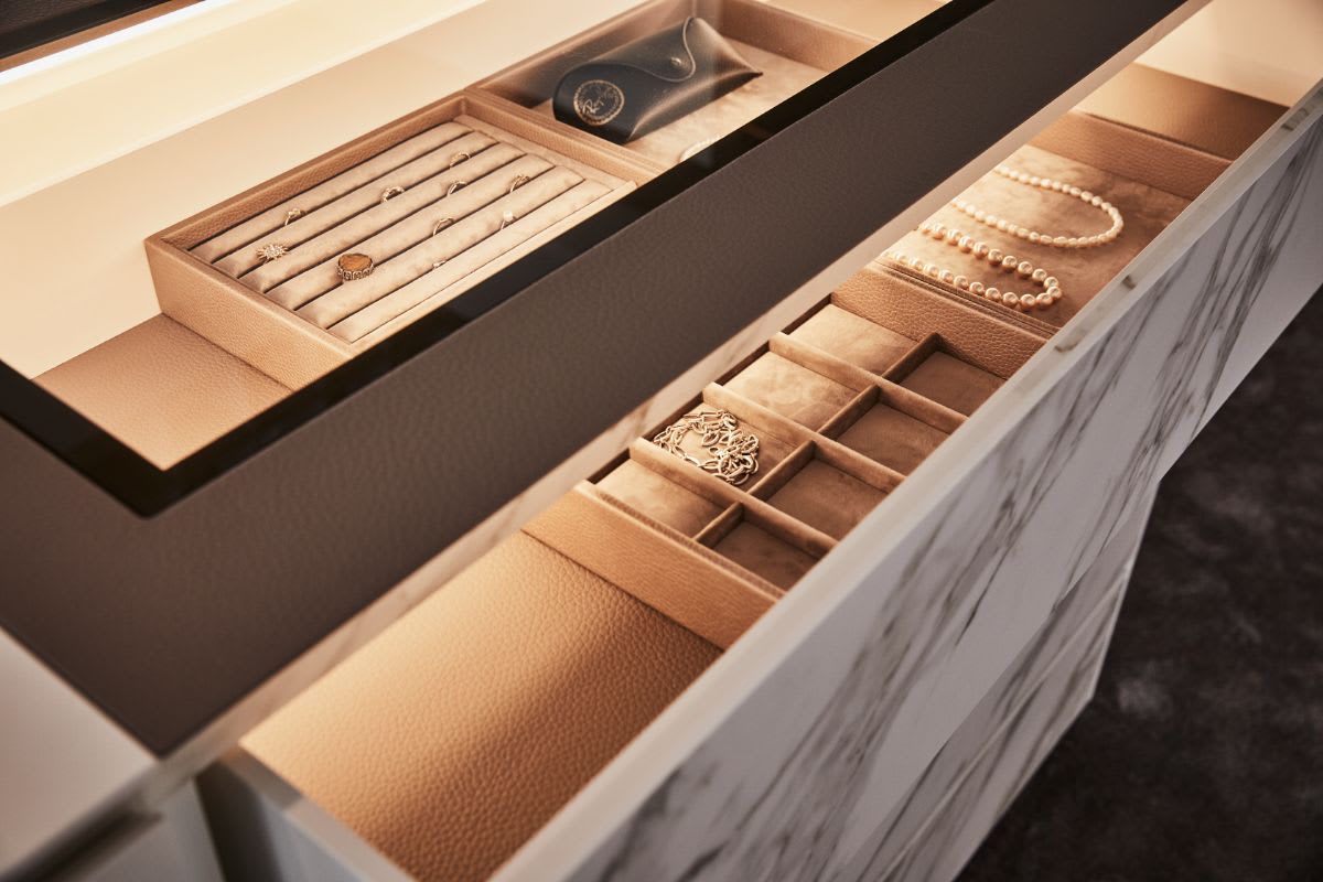 walk-in closet island features custom jewelry organizers in drawers