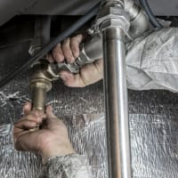 Plumber installing steel pipe fittings
