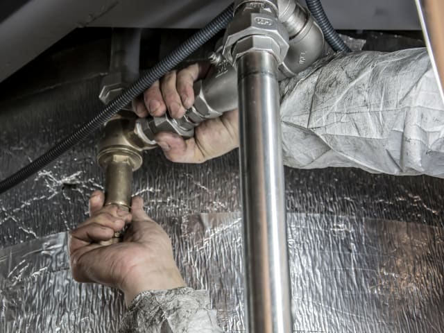 Plumber installing steel pipe fittings