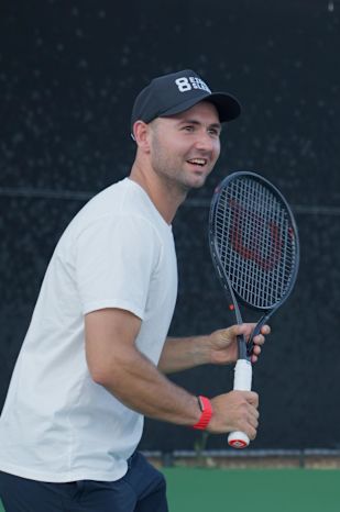 Anton Dubrov holding a racket on court