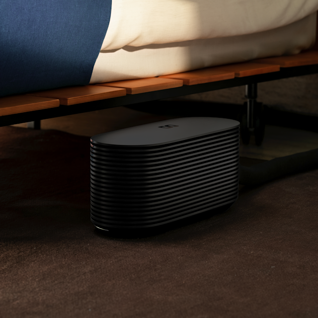 The Pod 6 Hub standing under a bed frame, its height and width marked.
