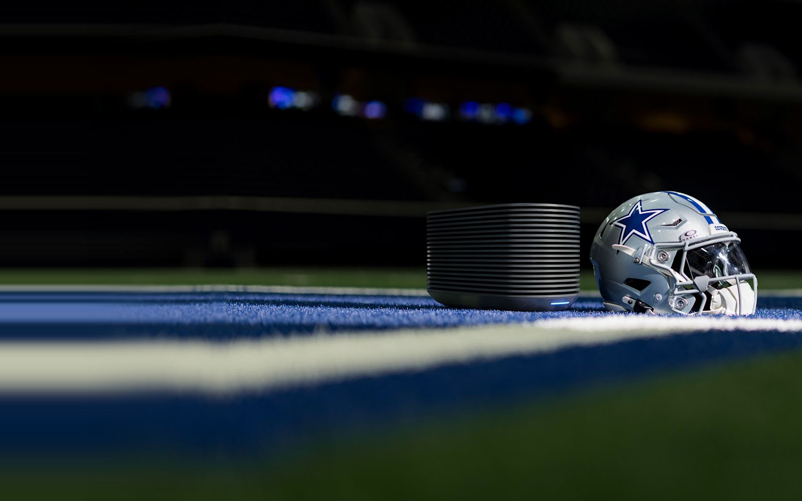 The Pod 6 Hub beside a Dallas Cowboys helmet on the field at AT&T Stadium