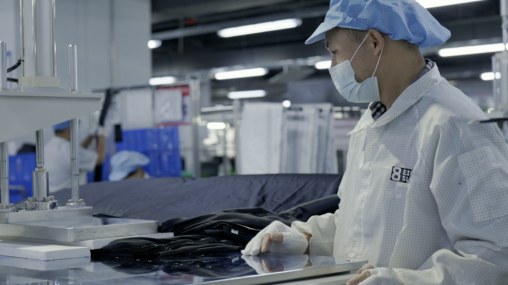 An Eight Sleep employee inspects a new Pod