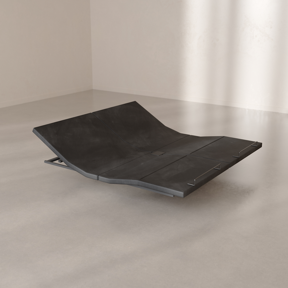 The Base articulated at the head and foot, resting on the floor in a bright room.