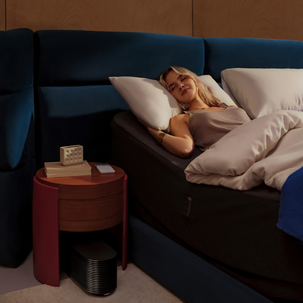 A woman lying in a raised bed at night, reducing back pressure.