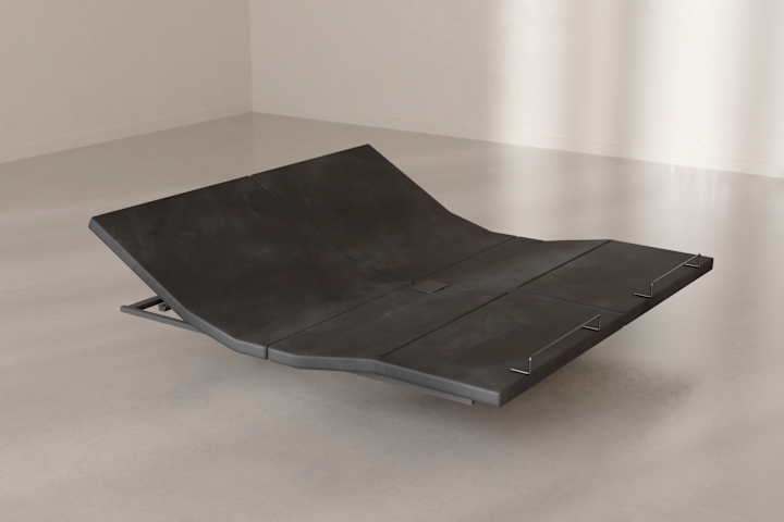 The Base articulated at the head and foot, resting on the floor in a bright room.
