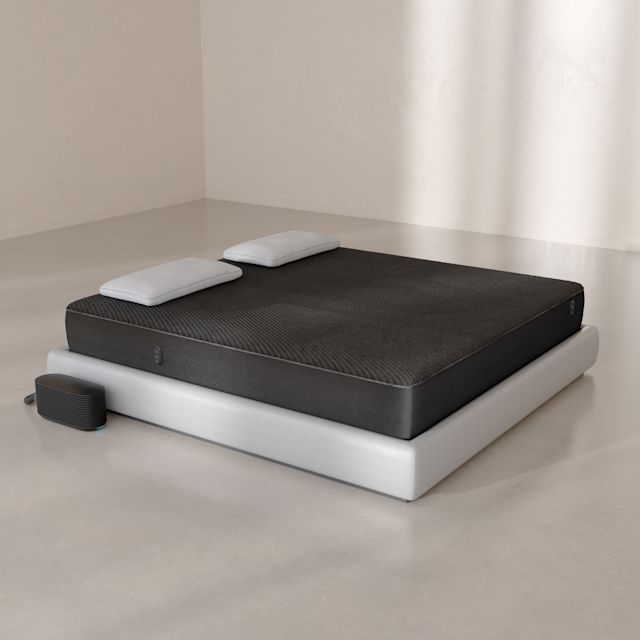 The Pod 6 Cover fitted over a mattress with the Hub on the floor beside it.