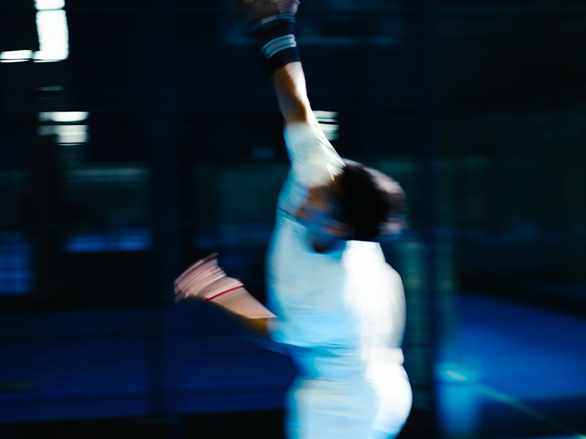 A tennis player mid-serve