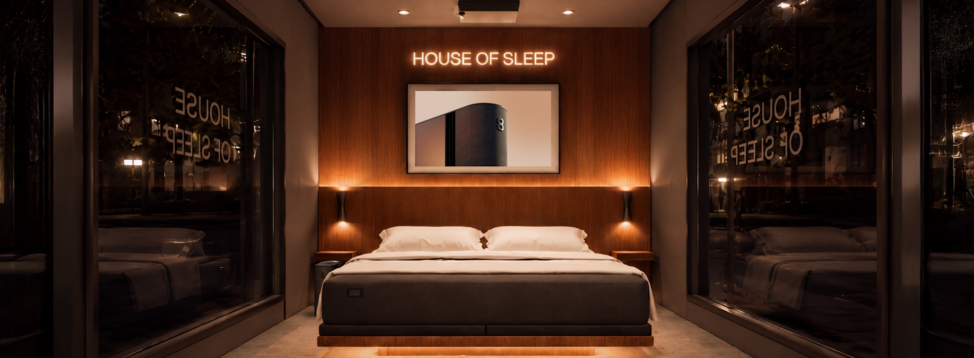 Interior of the House of Sleep mobile showroom, with a neon HOUSE OF SLEEP sign above the bed