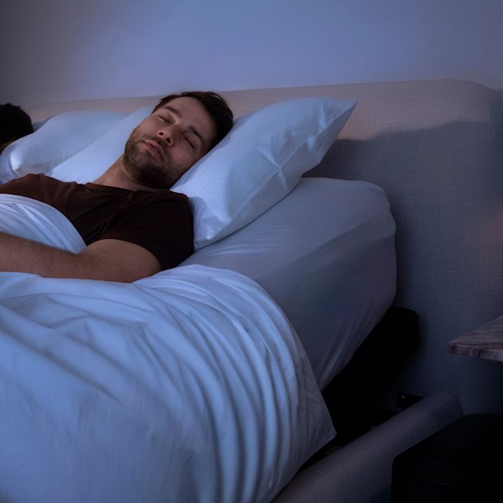 A couple asleep in bed at night