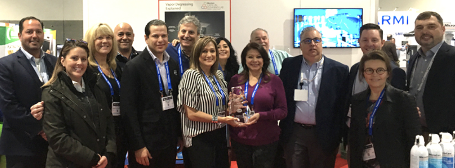 EIS employees accept MicroCare award for Distributor of the Year