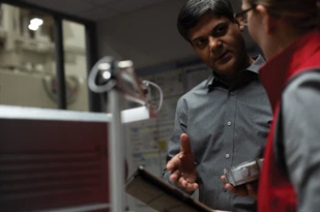 Women from Loctite talking to man while holding iPad