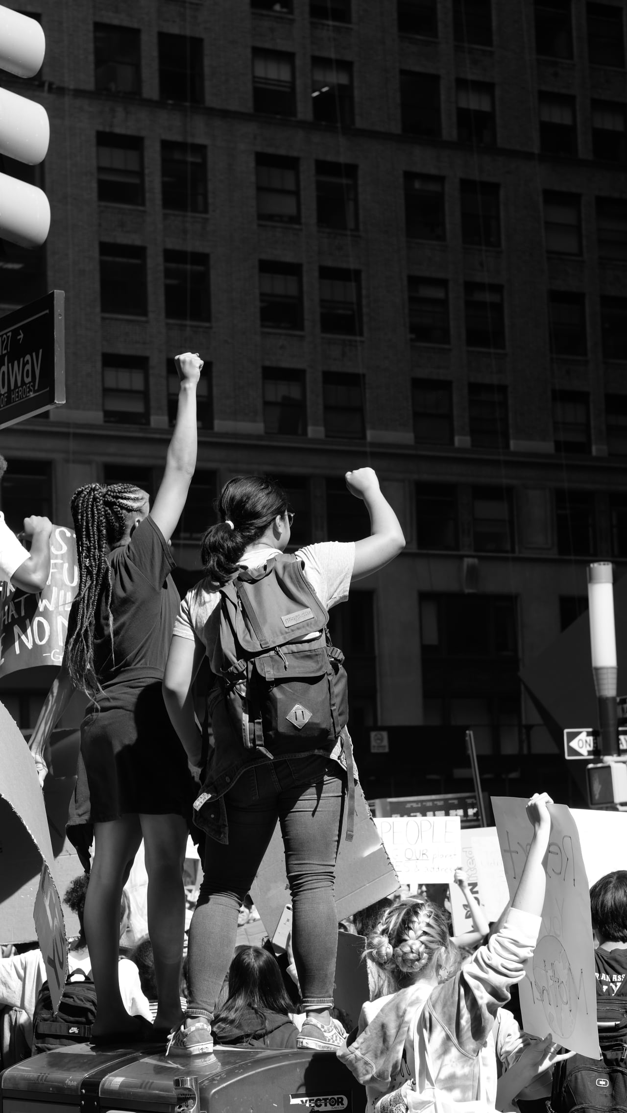A pair of young protesters leads the crowd in a chant before the police can come to shoo them off the garbage cans
