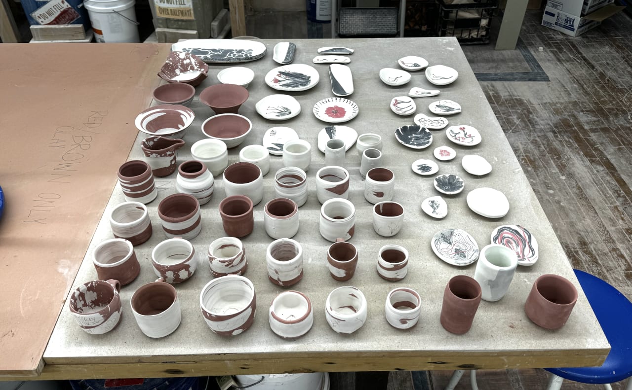 My collection of greenware bowls, cups, and plates ready to be fired
