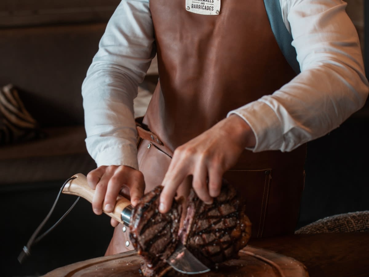 Carving a cut of beef at Beef Lodge, the Lodge Park restaurant in Megève