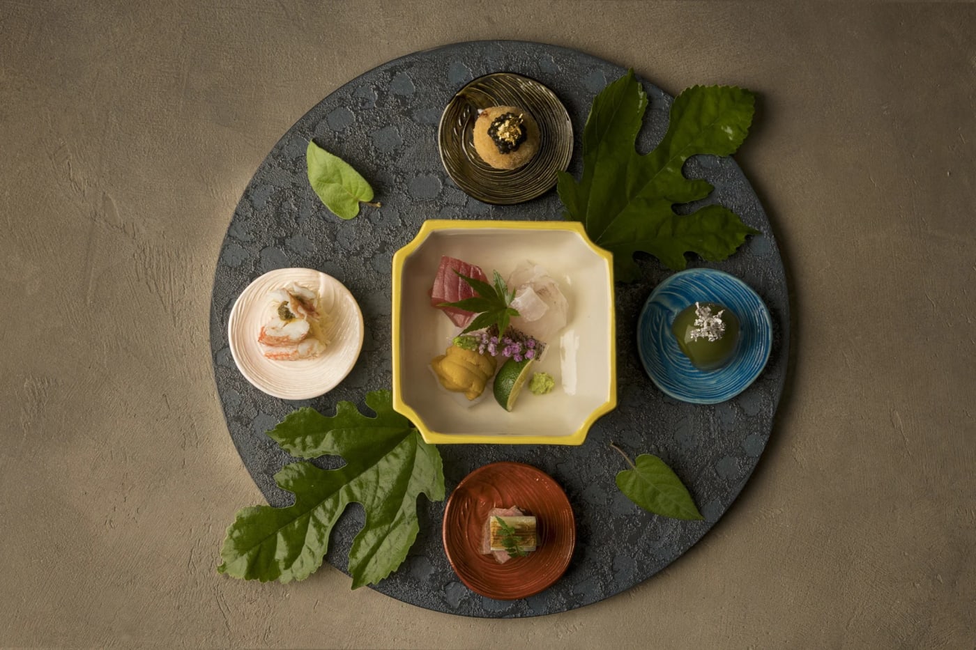 Dinner tray at the Hoshinoya Asuka resort, small colourful dishes on a stone tray