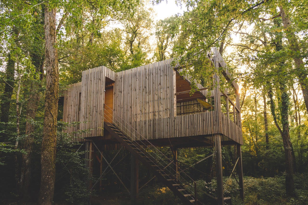 Lodges des Loire Valley Lodges auf Pfählen, Außentreppen und helle Holzverkleidung im Unterholz von La Duporterie
