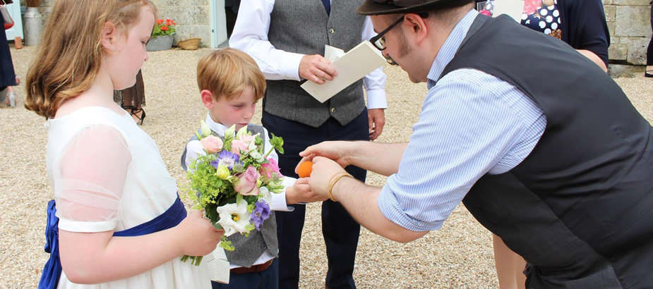 Neil entertains a boy with some close-up magic