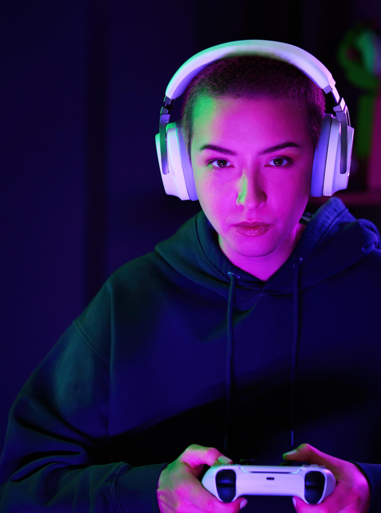 Streamer playing game with a white headset and a white controller