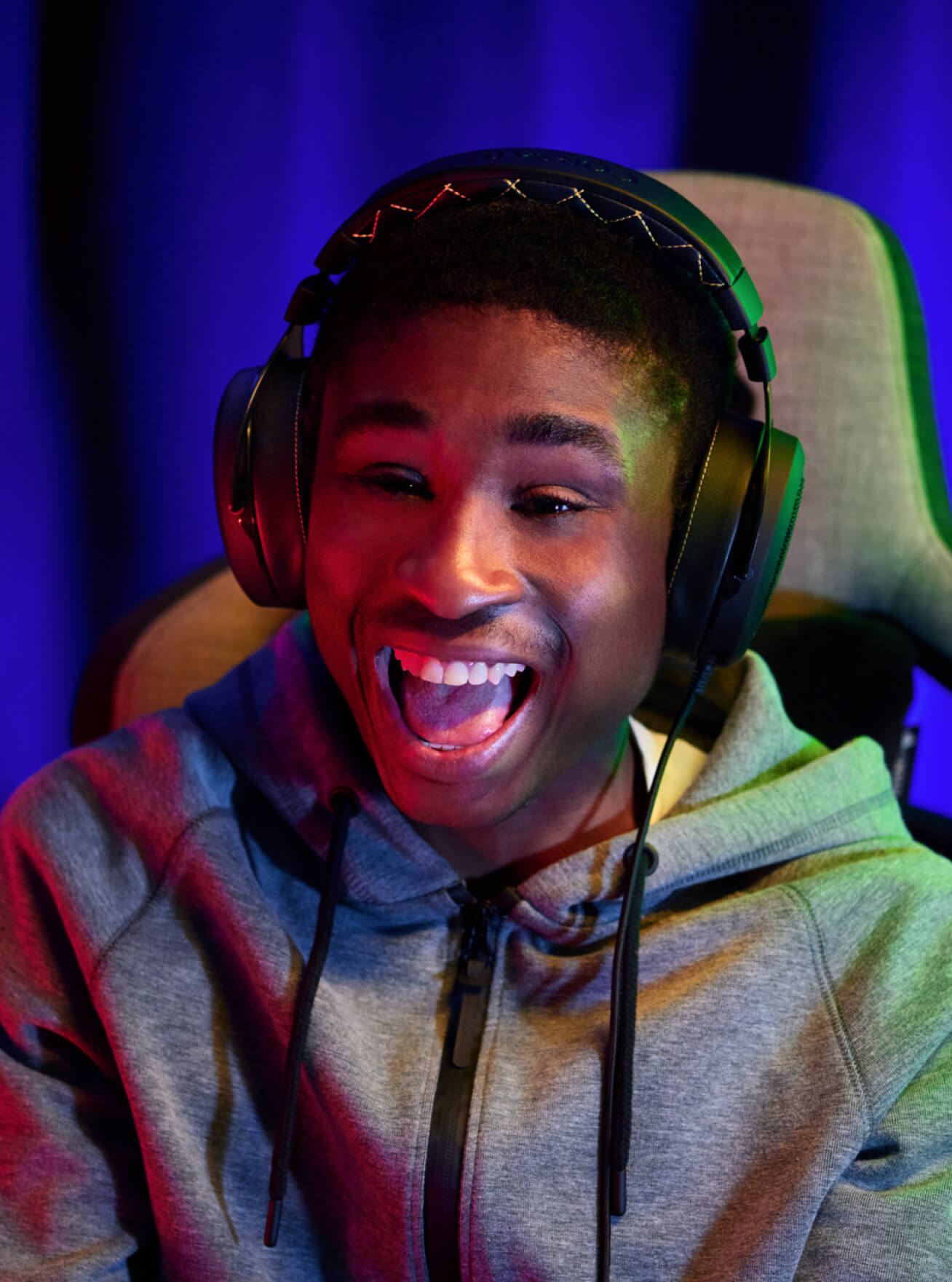 Streamer with a black headset playing game, being excited