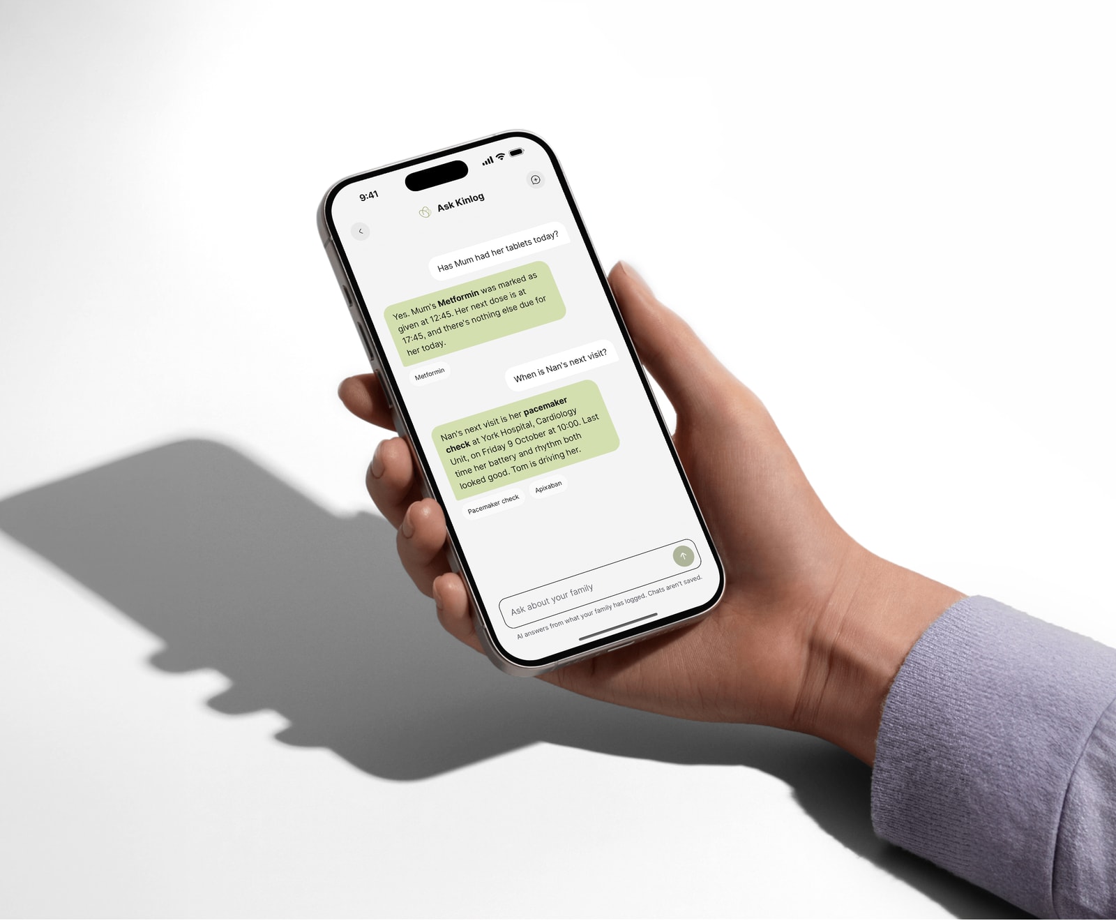 Hand holding an iPhone with Ask Kinlog answering whether Mum's Metformin was given, and when Nan's next visit is, with the sources it used