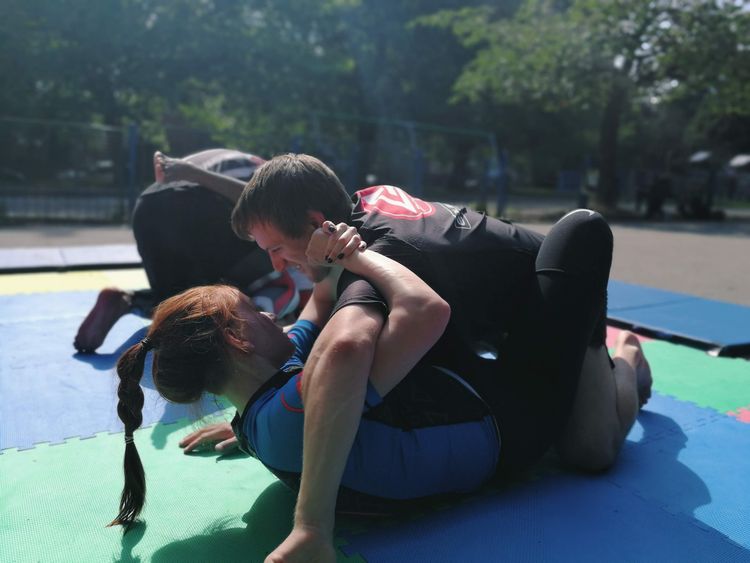 Two people practising jiu-jitsu