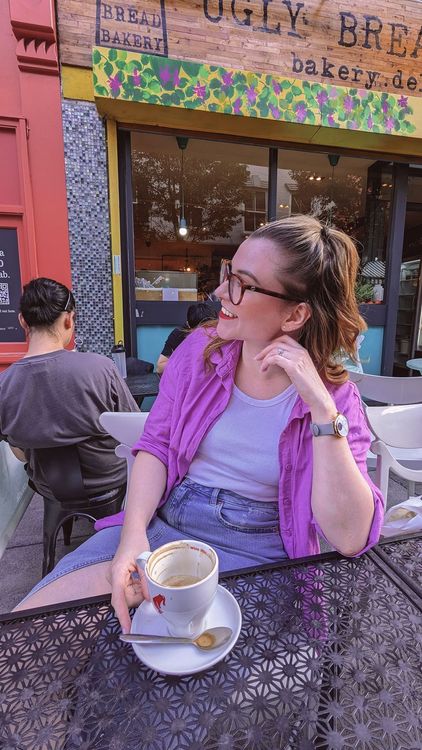 A woman sat drinking coffee