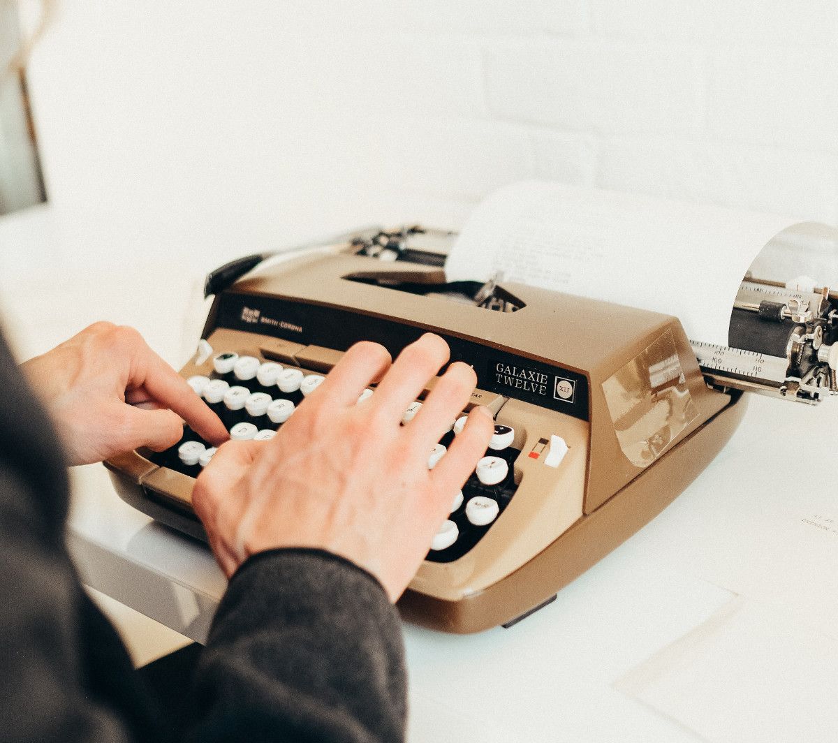 Person typing on a typewriter