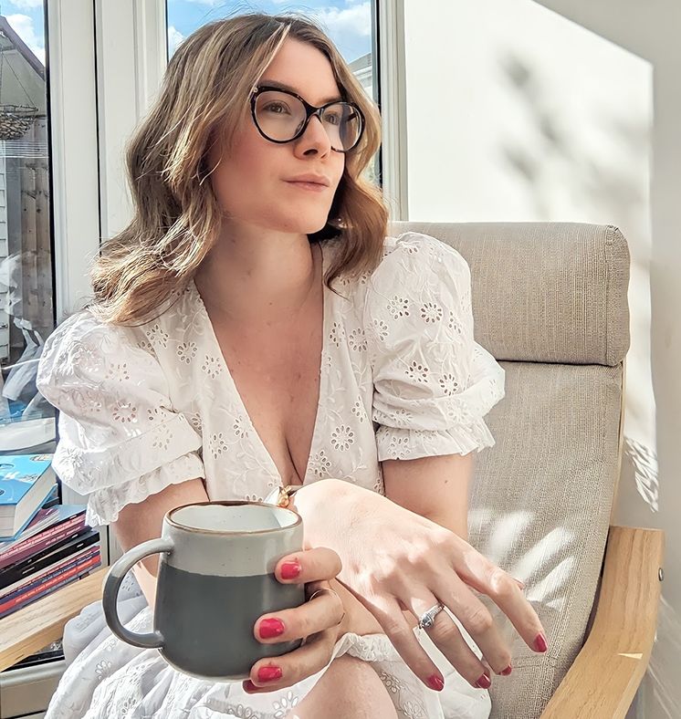 A woman sat drinking coffee