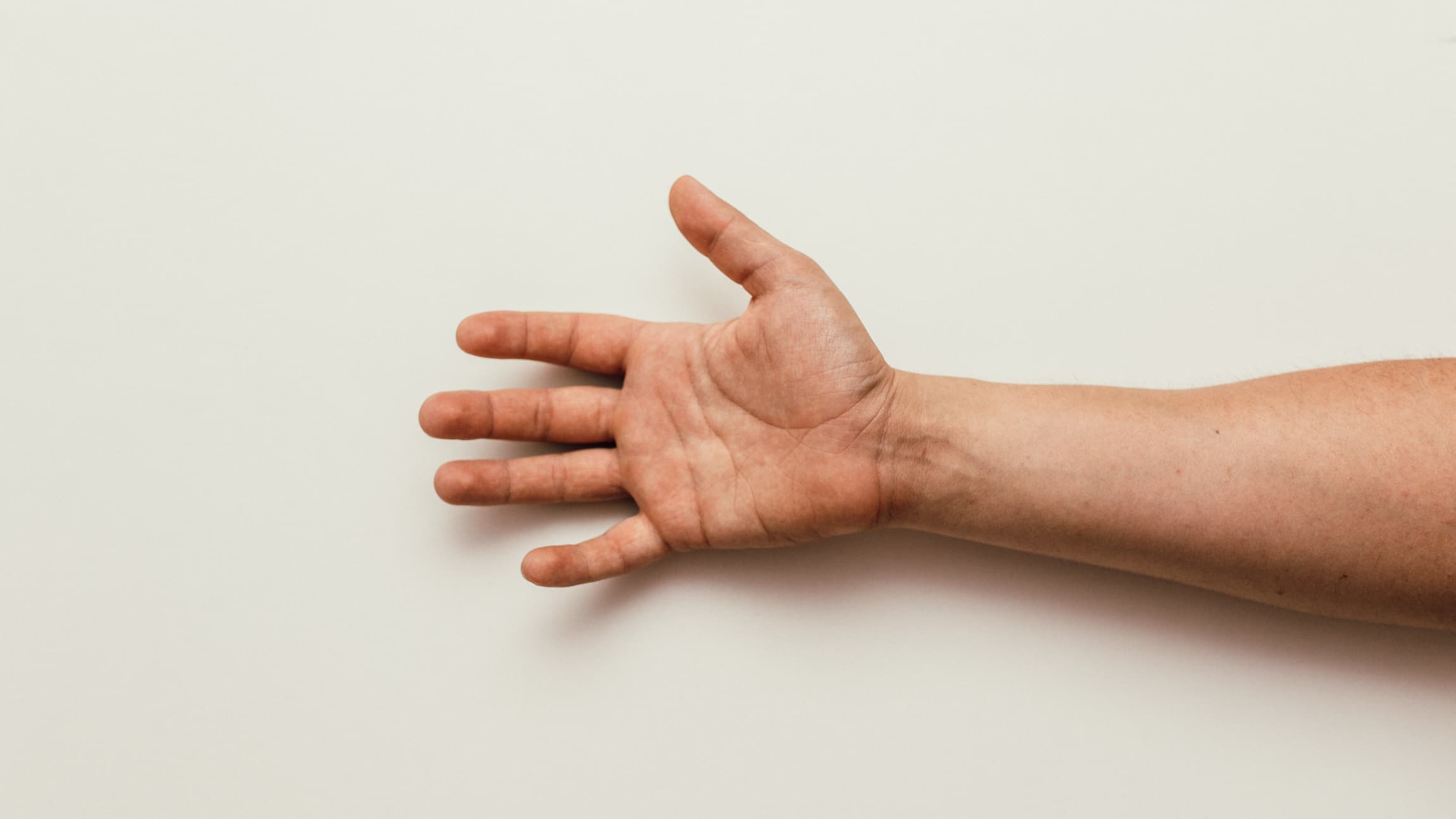 An open hand reaches into frame from the right side.