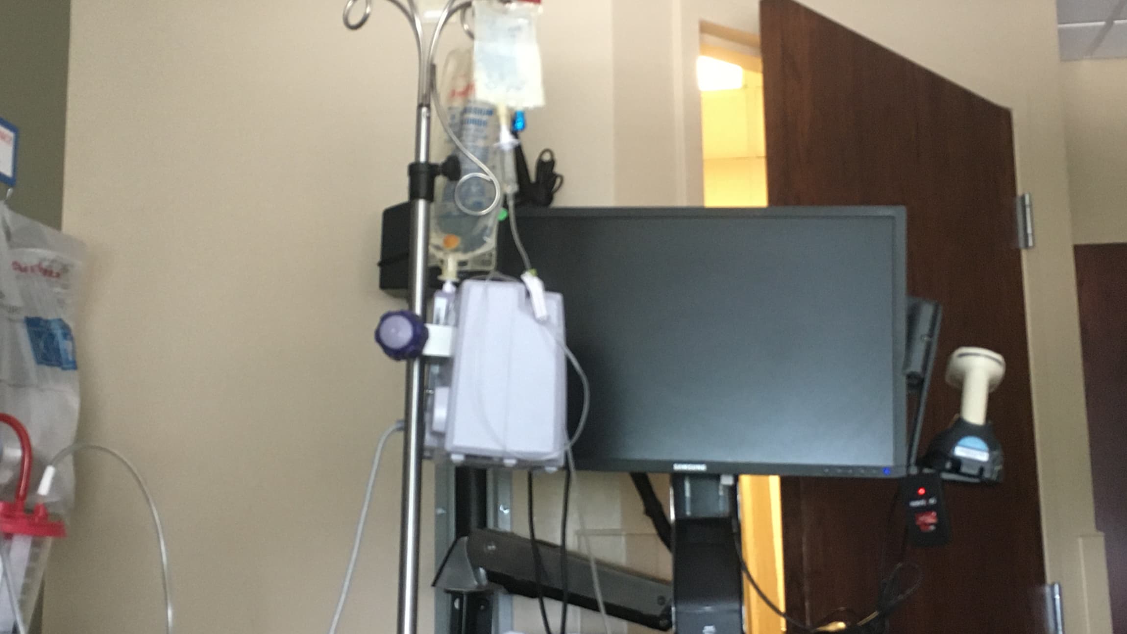 Photo of mom's IV pole, IV bags, NG tube, and hospital documentation computer.