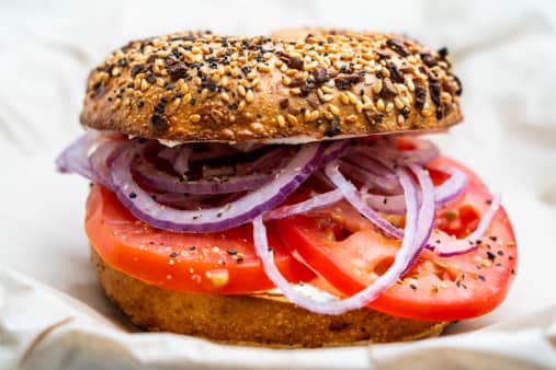 image of Toasted Bagel with Cream Cheese Tomato, Red Onions, and Lemon-Pepper