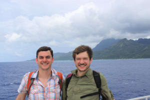Adam Boyko and Ryan Boyko on a boat while traveling the world to study dog DNA.