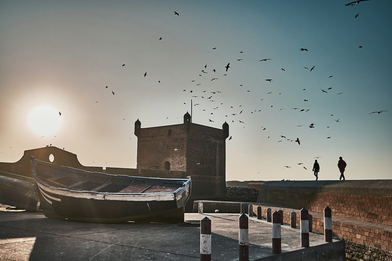 Essaouira sea fortress silhouetted against a golden Atlantic sunset