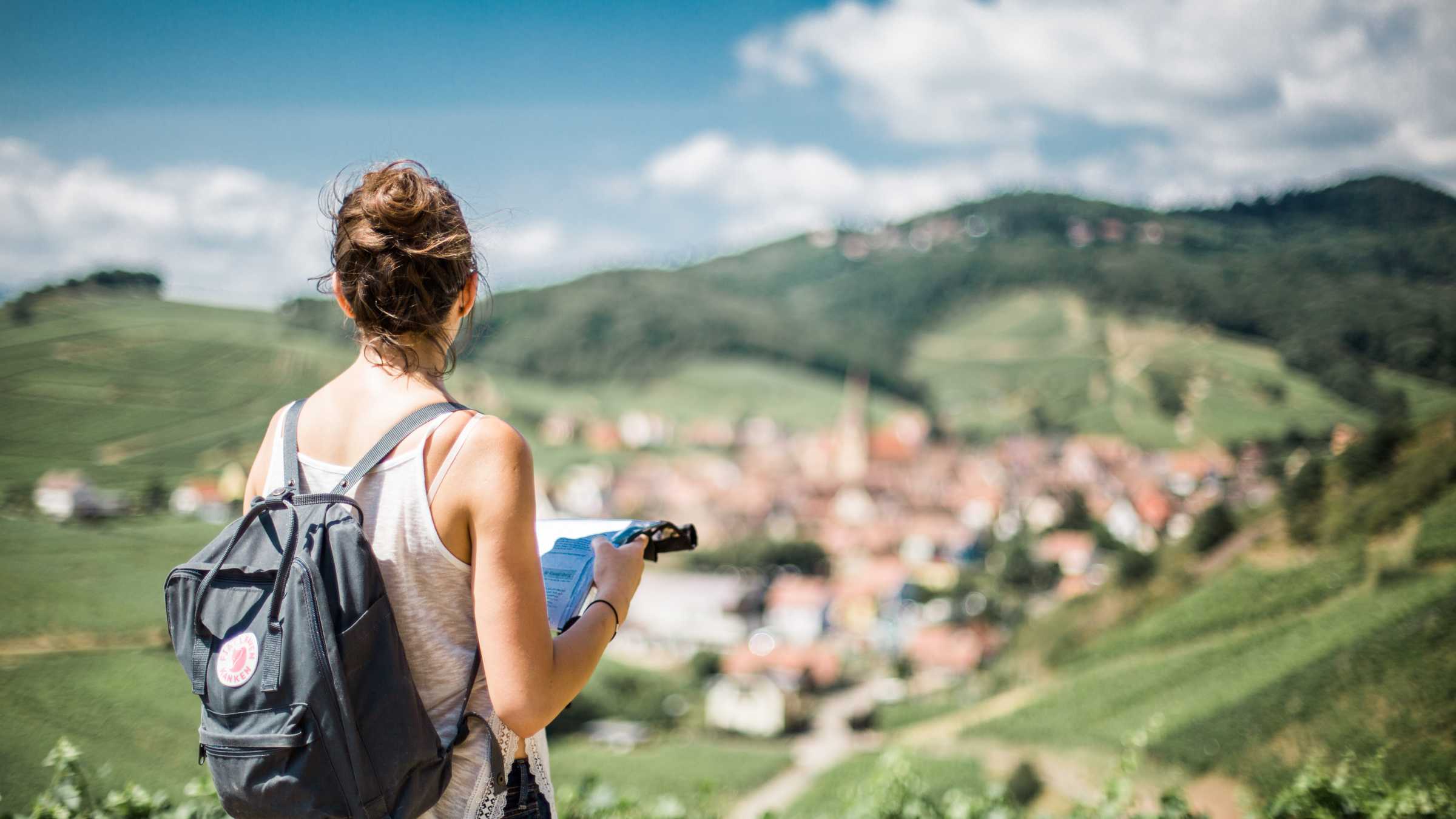Young walker looking out over blurred village.