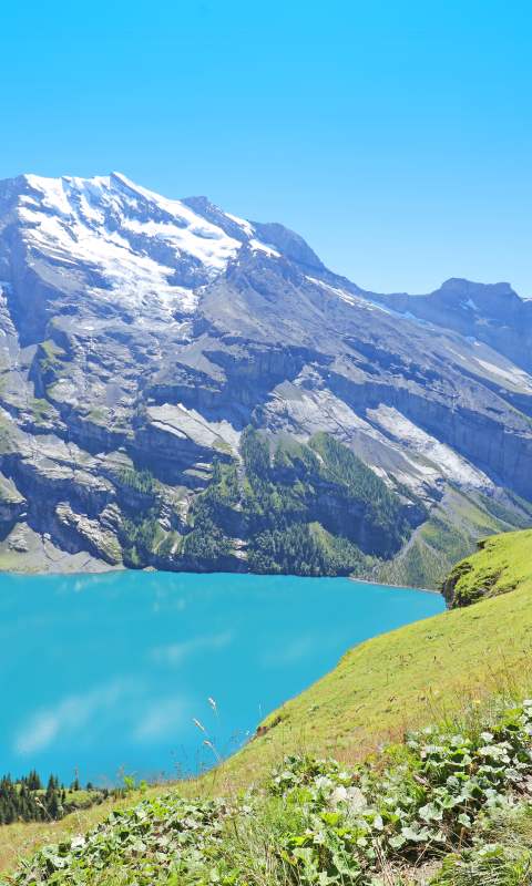 Hiking at Lake Oeschinensee in Berner Oberland in Central Switzerland