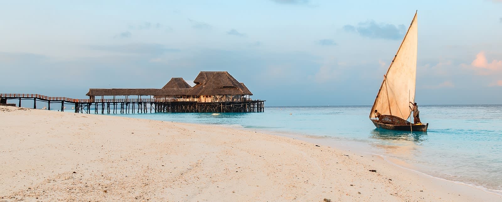 Beautiful sunrise over ocean with fishing boat, fishermen, hut, Nungwi, Kendwa, Zanzibar island, Tanzania Africa Tanzania travel