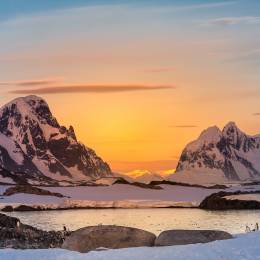 Enchanting Travels Antarctica Tours Beautiful snow-capped mountains against the sunset sky in Antarctica