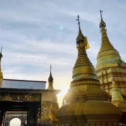 Myanmar_Golden pagodas on top of Mandalay Hill with sun setting in the background