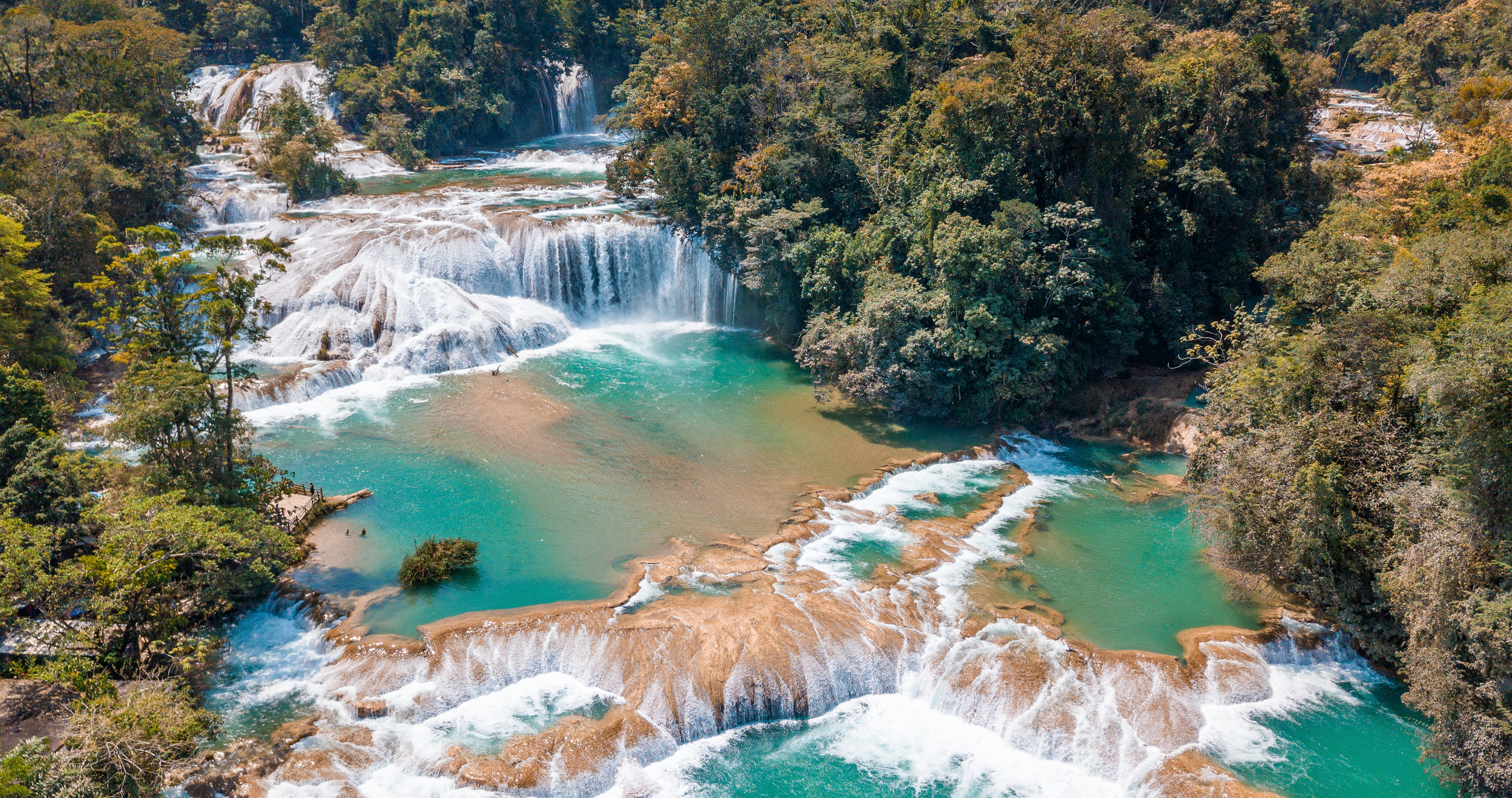 Enchanting-Travels-Mexico-5 is it safe to travel to Mexico? - Aerial view of the majestic turquoise waterfalls at Agua Azul in Chiapas, Mexico, Central America